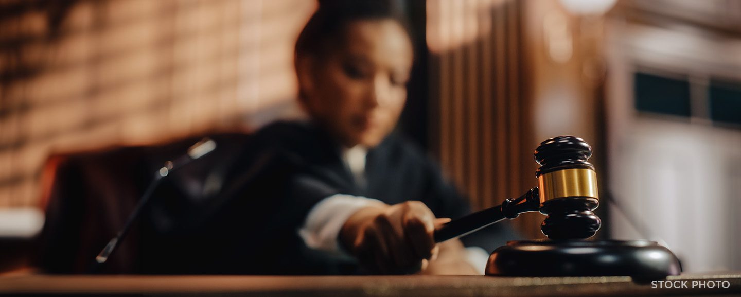A judge banging her gavel in a courtroom.